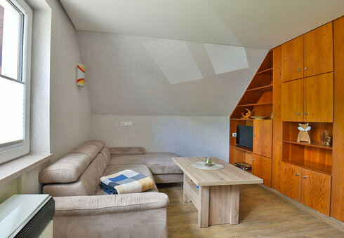 Wohnzimmer mit Couch und TV