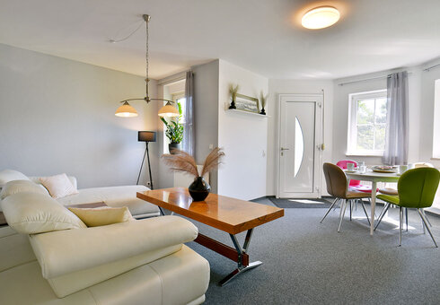 Wohnzimmer mit Couch und Esstisch