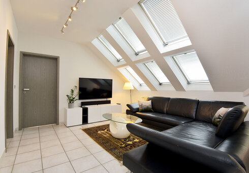 Große Ferienwohnung - Wohnzimmer mit Couch und TV