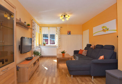 Wohnzimmer mit Couch und TV