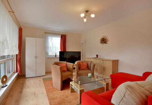 Wohnzimmer mit Couch und TV